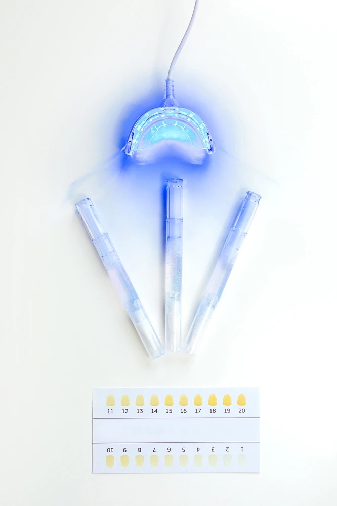 Professional teeth whitening light, pens, and shade guide for cosmetic treatments at Clearly Dental Riverwood